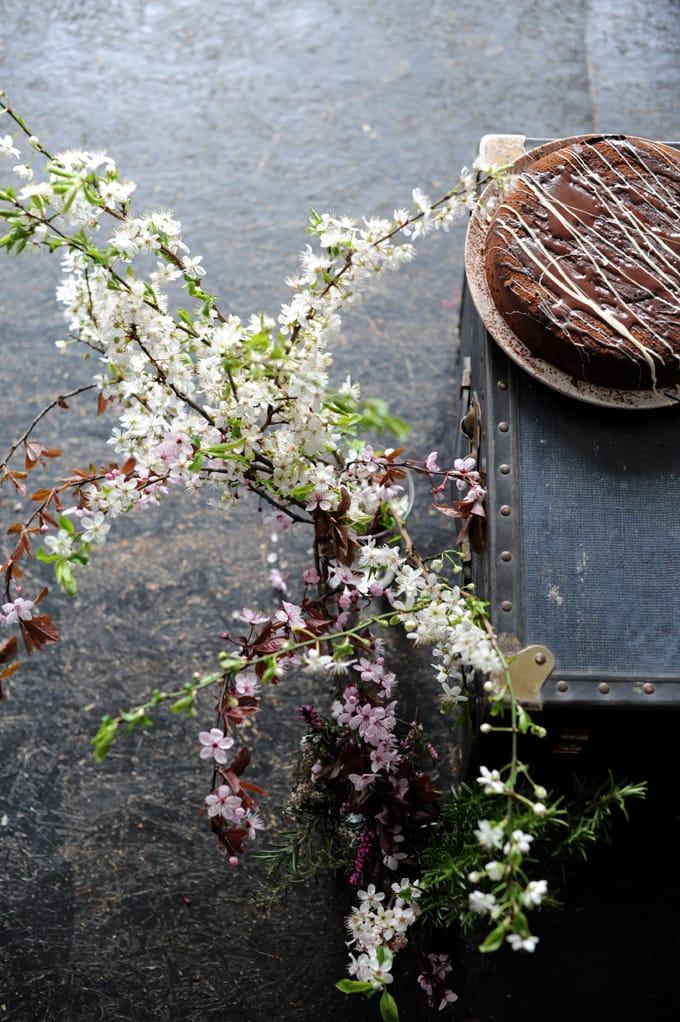 beautiful flowers next to chocolate sourdough cake