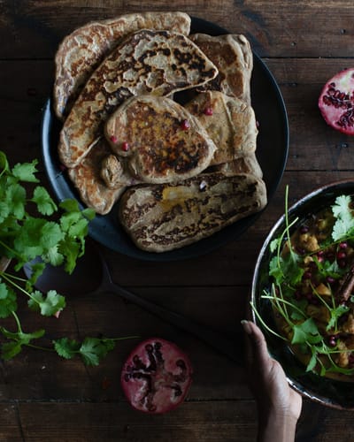 sourdough flat breads on the table with a curry