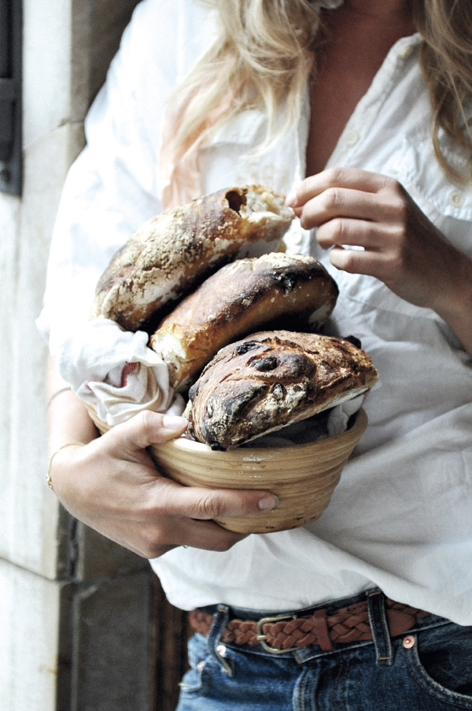 three fresh sourdough loafs being held