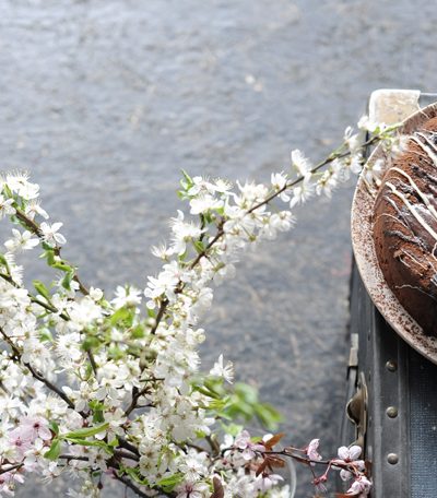 beautiful flowers next to chocolate sourdough cake