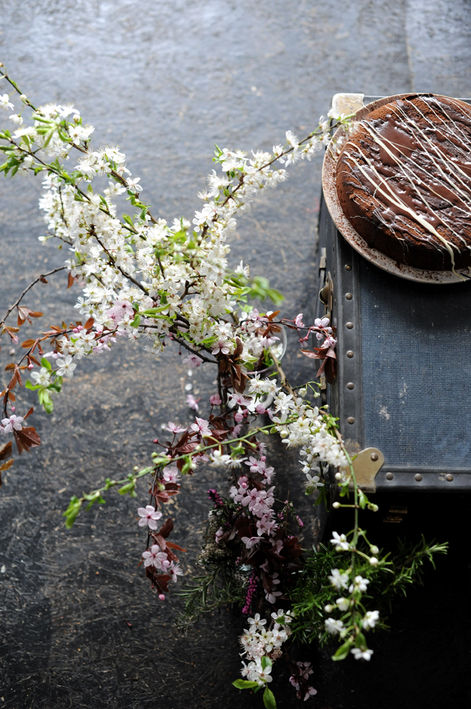 beautiful flowers next to chocolate sourdough cake 