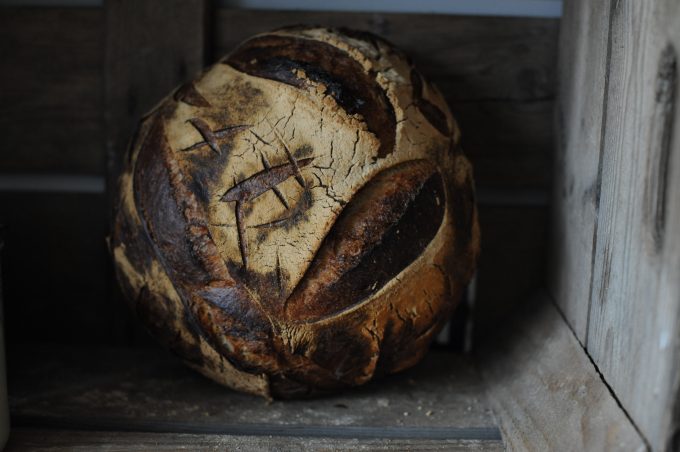 large sourdough loaf in apple crate