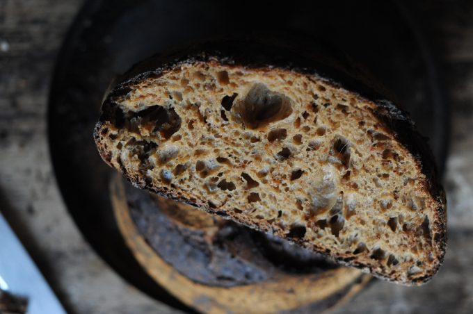 malted wholegrain flour sourdough loaf cut in half