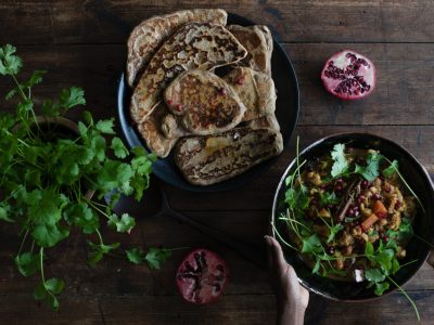 sourdough flat breads on the table with a curry