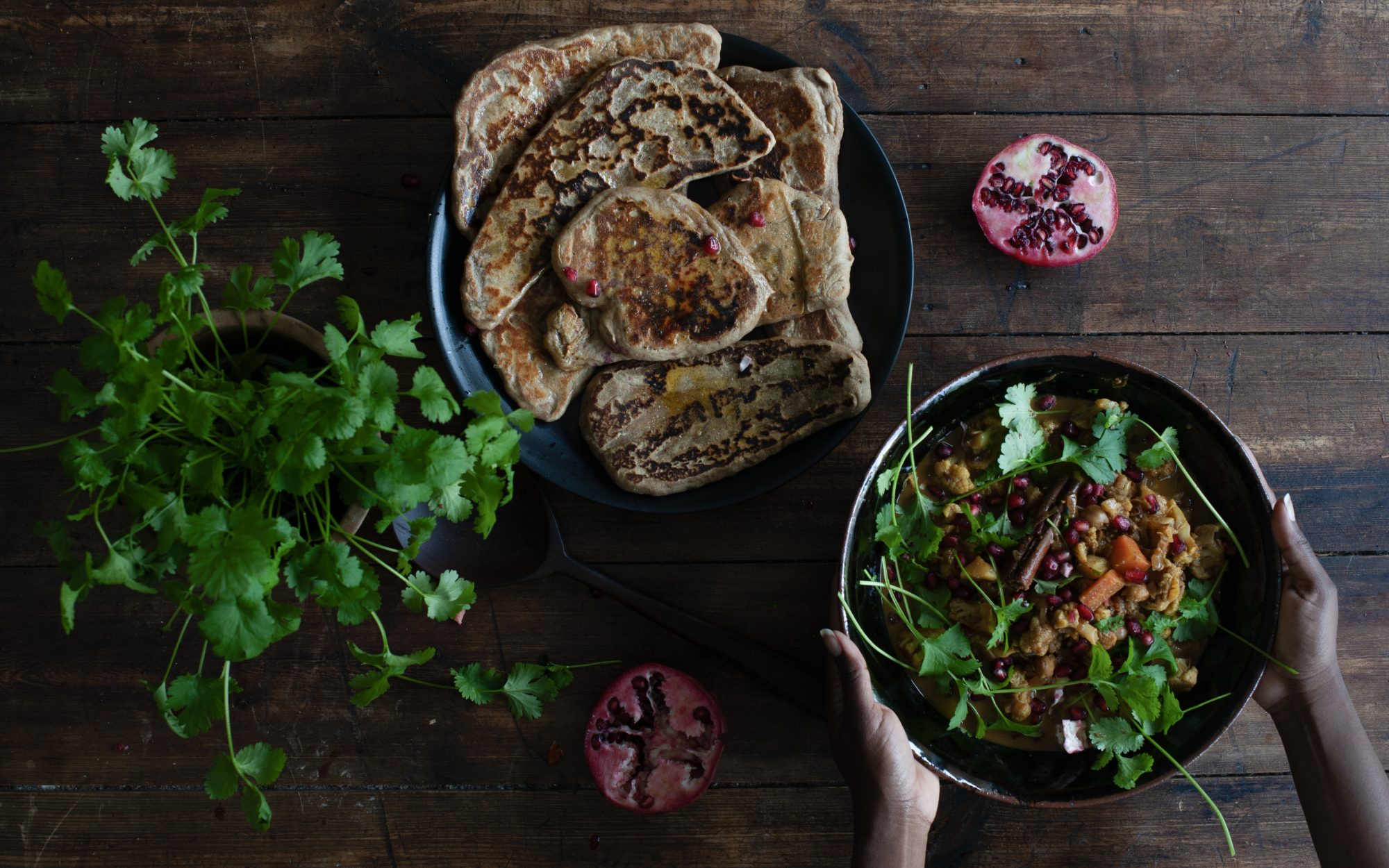 sourdough flat breads on the table with a curry 