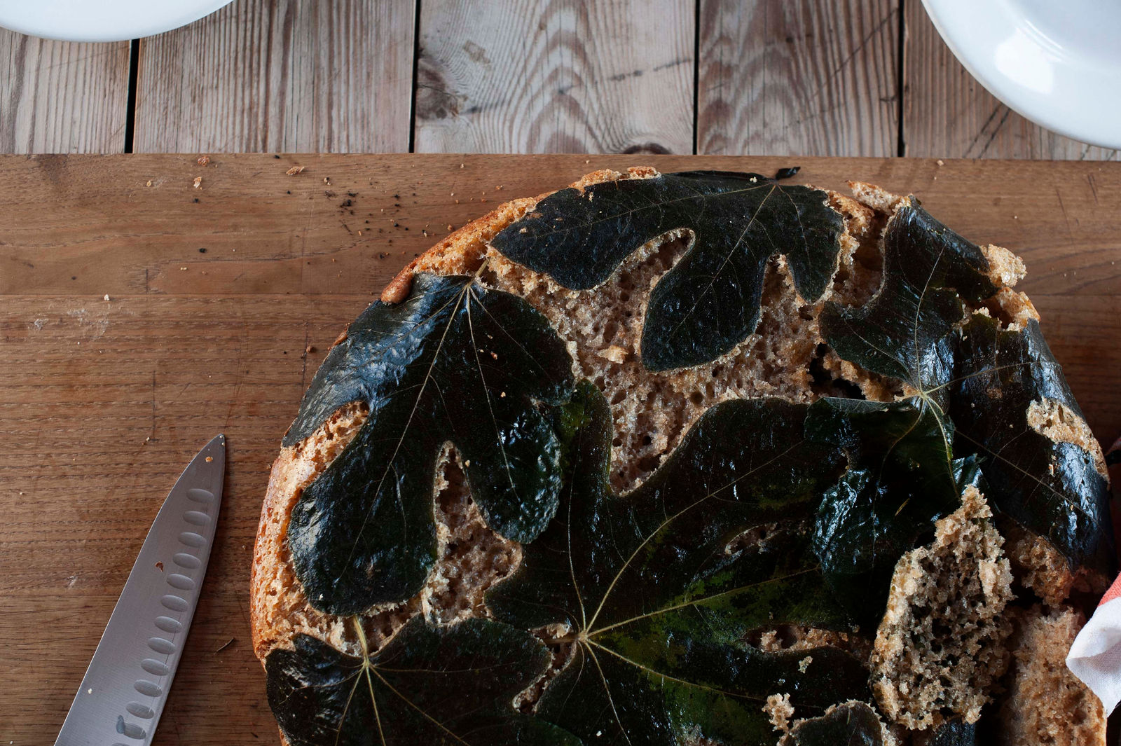 fermented sourdough bread close up, topped with leaves.